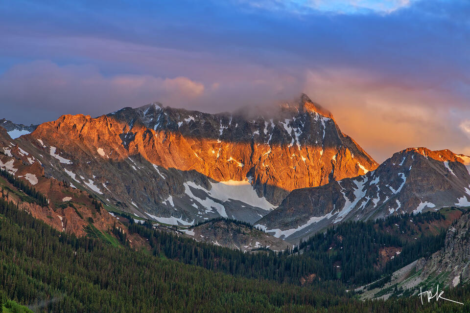 Limited edition print of Colorado’s Capitol Peak bathed in a band of warm sunlight after a summer thunderstorm.
