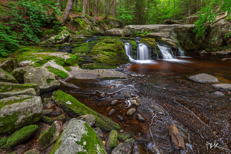 Limited edition print of the first falls at Enders Brook in Granby, Connecticut in spring with many moss-covered rocks to the left of the waterfall.