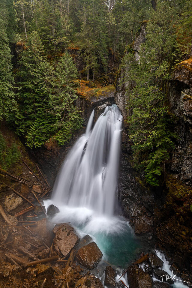Limited edition print of Vancouver Island’s Lady Falls surrounded by a dense forest of conifers.