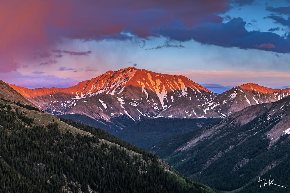 Limited edition print of Colorado’s La Plata Peak bathed in the warm light of sunset as a storm approaches.