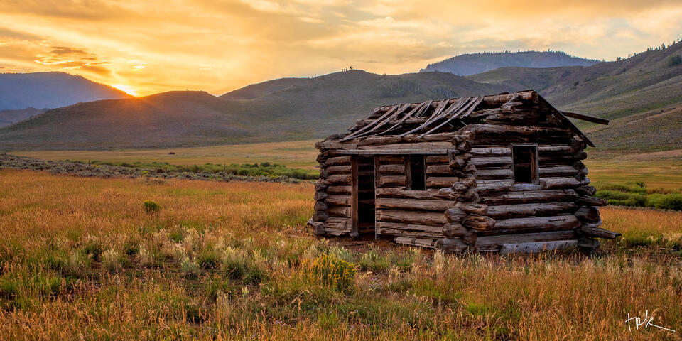 Limited edition panoramic print of an old log cabin at sunset near Granby, Colorado.