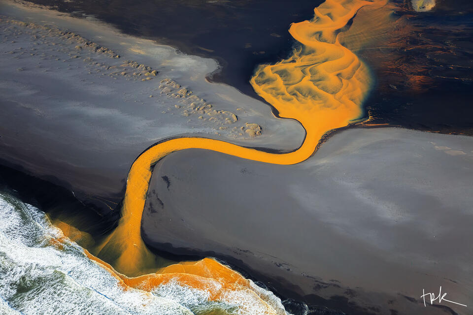 Limited edition print of an abstract Icelandic scene created by mineral-infused river water traveling across a black sand beach to the ocean.