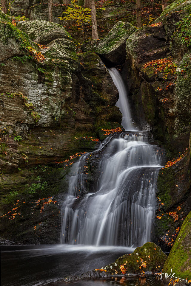 Limited edition print of the second falls at Enders Brook in Granby, Connecticut with red autumnl leaves on the moss-covered rocks nearby.