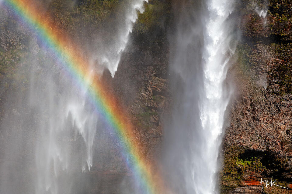 Limited edition print of a closeup view of an Icelandic waterfall with a rainbow in front of it.