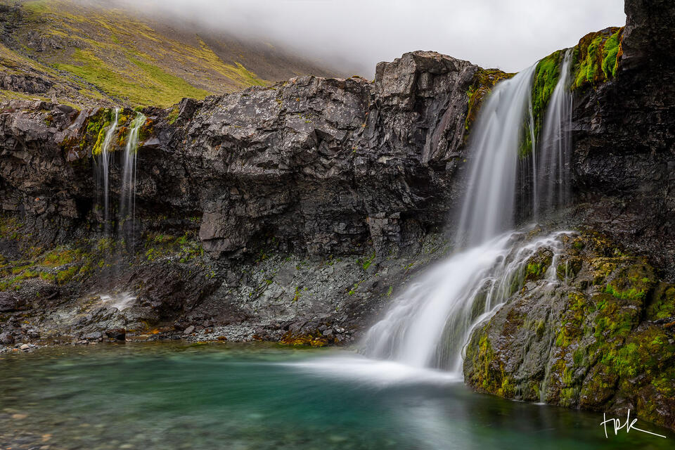 Limited edition print of two side-by-side Icelandic waterfalls, underneath low clouds