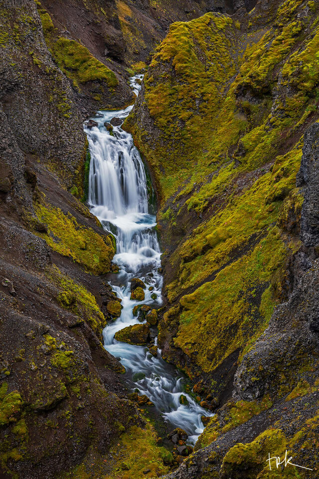 Limited edition print of Iceland’s Snekkufoss surrounded by green grass and moss.