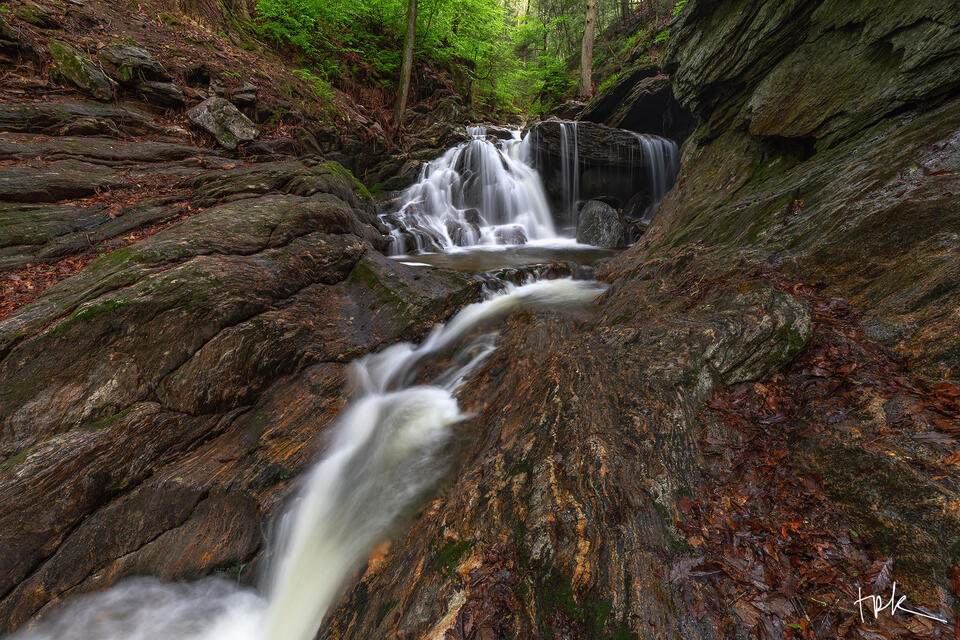 Limited edition print of the first falls at Spruce Brook in spring viewed from downstream with a chute of water in the foreground.
