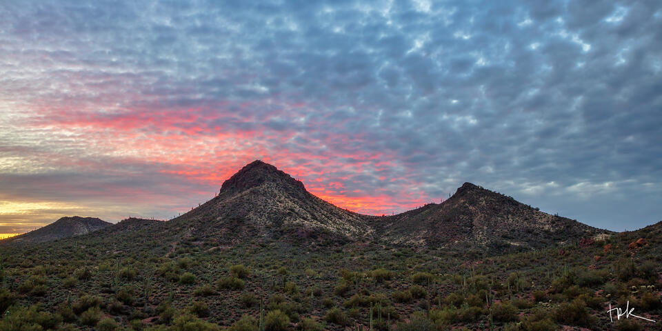 Limited edition panoramic print of a sharp ridge line under textured blue and pink clouds in Arizona’s Superstition Mountains.